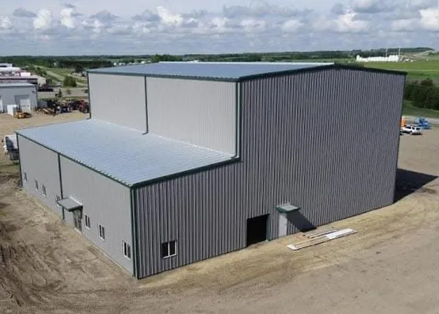 Completed grey PEB building with raised mezzanine bay section