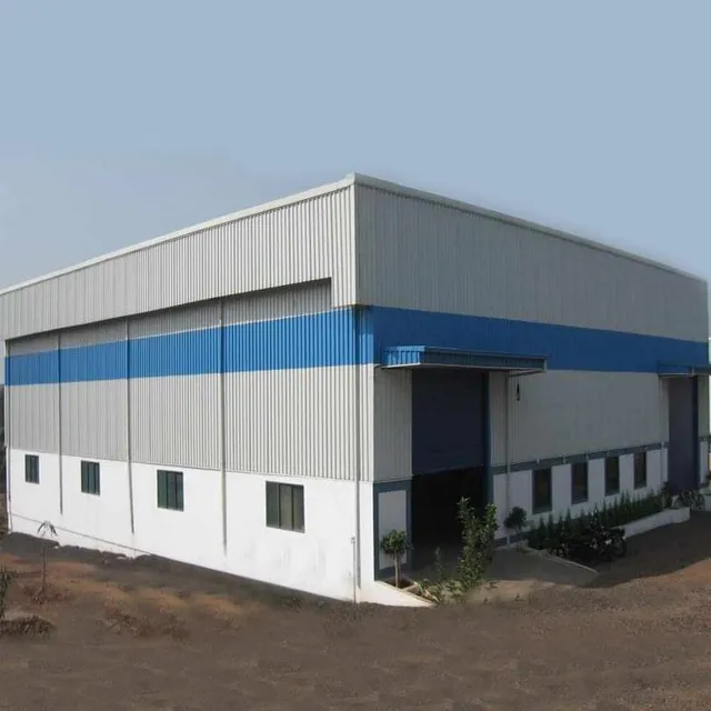 Completed blue and white PEB industrial warehouse with finished cladding