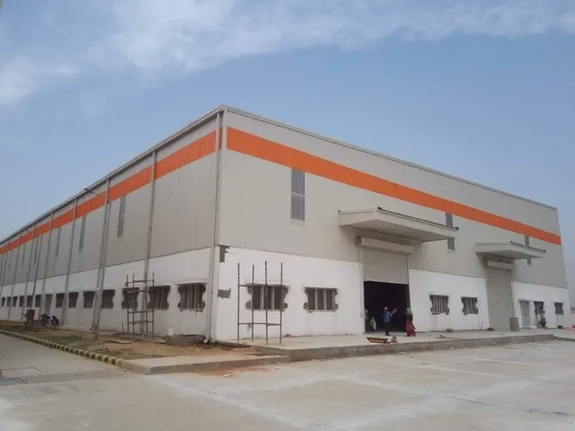 Large PEB warehouse with orange band cladding
